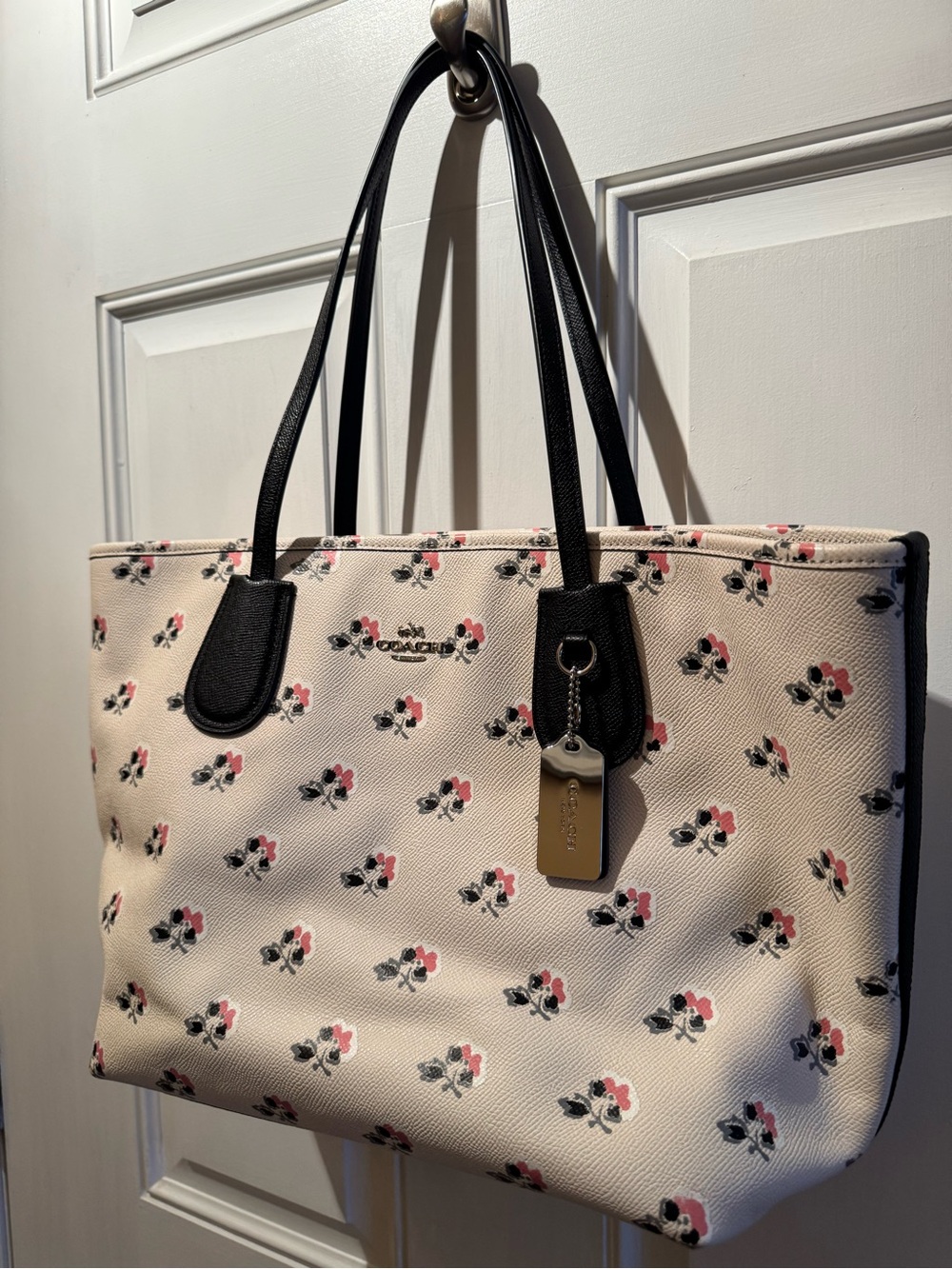 Coach Cream Floral Tote with Black Trim and Pink Accents.